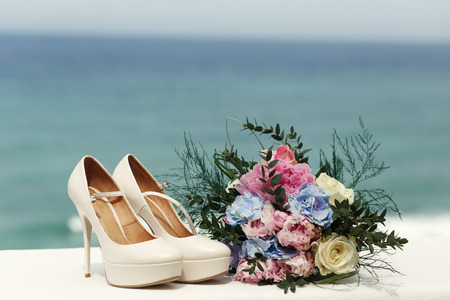 Gorgeous bouquet stands before the classy wedding shoesの写真素材