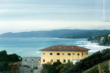 Look at the azure sea over the yellow houseの写真素材