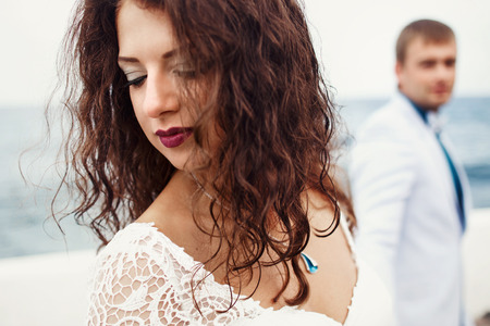 Birde hides her face behind the brunette curlsの写真素材