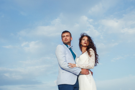 Look from above at the fatal couple standing under the blue skyの写真素材