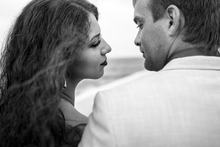 Black and white picture made from behind man and woman admiring each otherの写真素材