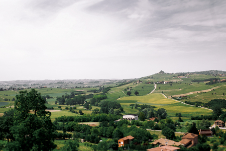 Grey clouds cover gorgeous green fieldsの写真素材
