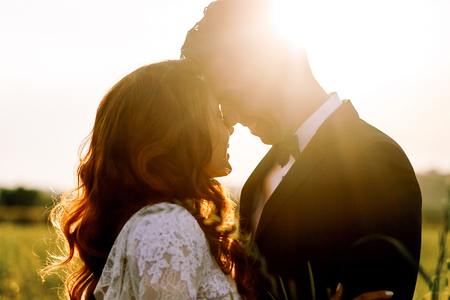 Evening sun hides newlyweds silhouettesの写真素材