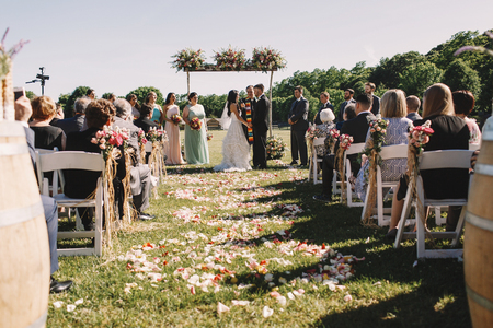 Look from the beginning of a path to altar at happy wedding coupleの写真素材
