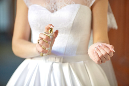 Bride speays perfumes on her delicate wirstの写真素材