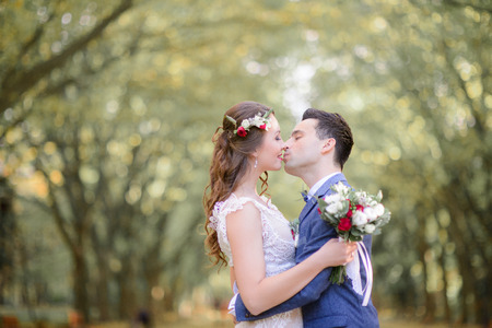 Angelic bride and groom kiss hugging each other tightlyの写真素材
