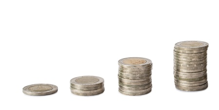 Hand put coins to cumulative on isolate white backgroundの写真素材