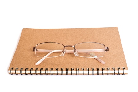 glasses and notebook on isolate white backgroundの写真素材