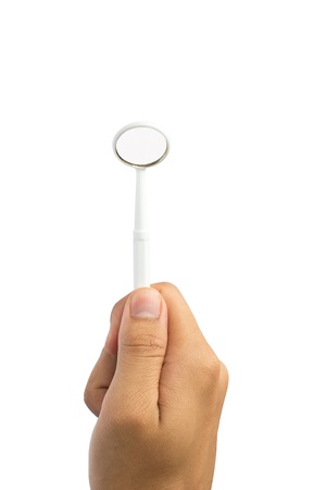 Dental mirror in hand on isolate white backgroundの写真素材