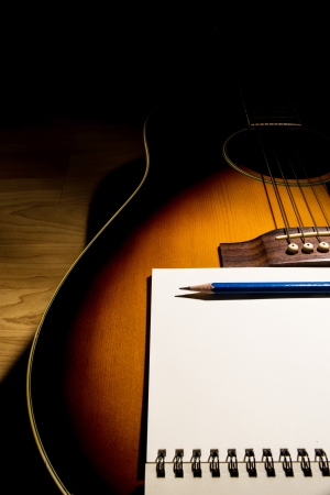 close-up Notebook and pencil on guitar,Writing musicの写真素材