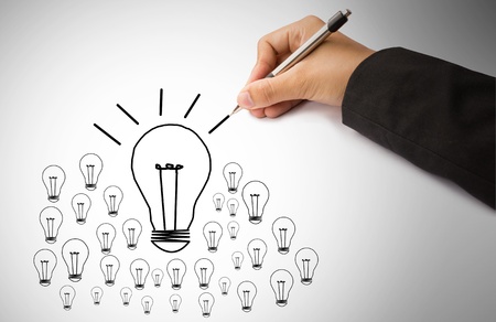 hand of business writing lamp and lightの写真素材