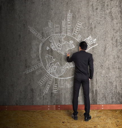 men in suit drawing earth and city on old wallの写真素材