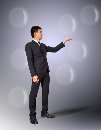 businessman stand holding  bubble,in bubble for your text or imageの写真素材