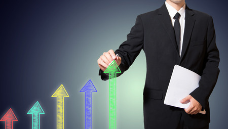 businessman drawing arrow more thanの写真素材