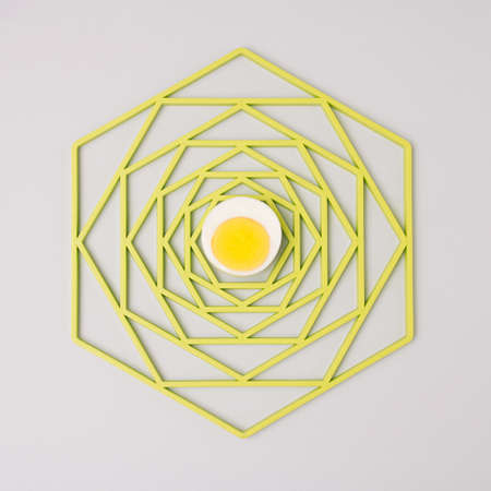 Egg on an abstract green tray. Minimal creative concept for Easter on gray bacground.の写真素材