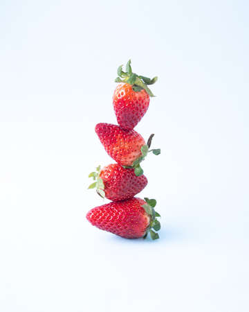 Strawberries vertically arranged on a light blue background.の写真素材
