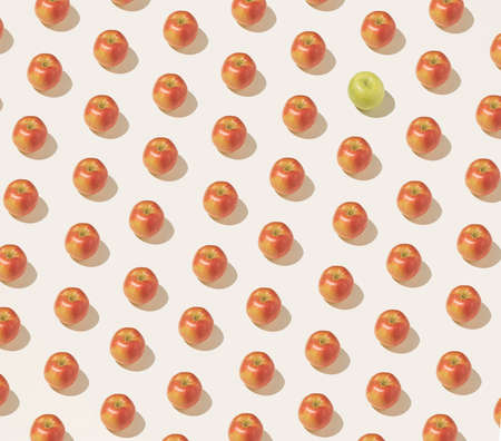 Fruity pattern made of red apples on a beige background