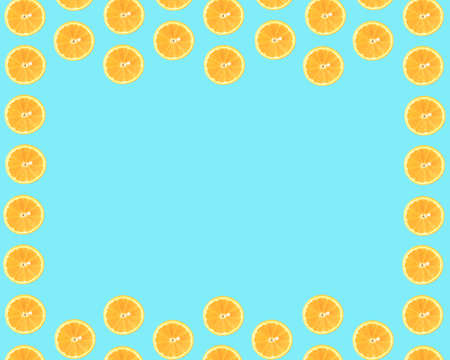 Summer pattern made of slices of orange on a light blue cyan background. Space for a message