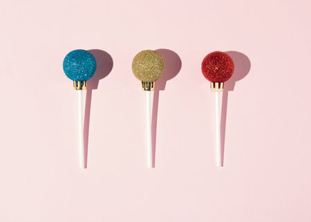 Lollipops made of New Year's  balls. Minimal concept of Christmas candy.