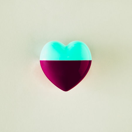 A heart whose one half is light green and the other burgundy. Minimalist concept of love on beige backgroundsの写真素材