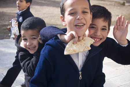 Muslim children from a closed school on the Temple Mount in Jerusalem are happy to get photographed during their lunch break.Strangers are not allowed in the area except for several hours a day, thus the mere fact of interacting with a stranger is an outsのeditorial素材