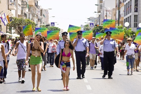 Police officers providing for safety during the march of the Gay Pride Parade in Tel Aviv, Israel, on 6/10/2011The slogans in Hebrew read: "My son is homosexual. SO WHAT?"Gay Pride Parades were held in numerous countries during month of June with people oのeditorial素材