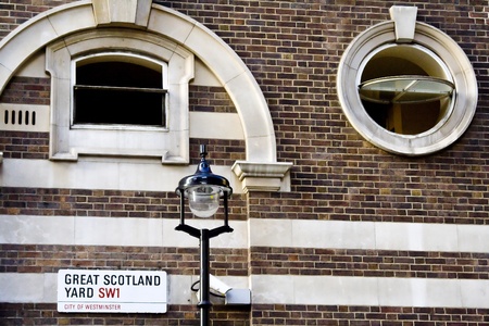 Brick wall on the Scotland Yard street with a street lamp.のeditorial素材