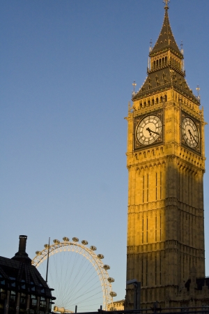 Famous clock tower of Big Ben and London Eye in London against sunset lighting.のeditorial素材
