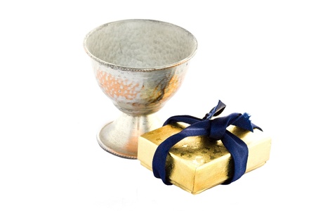 Golden gift box and old metal sneezer over white background.