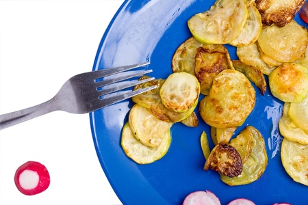Dish of marrow pumpkin fries with a fork and a small radish over whiteの写真素材