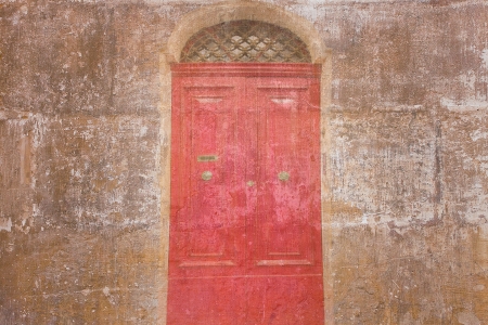 Retro wallpaper with a vintage red door の写真素材