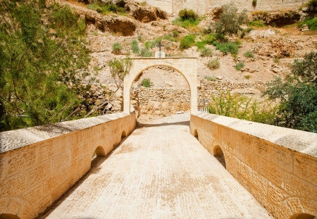 Stone bridge and a gate archway with Greek Orthodox Church symbolの写真素材