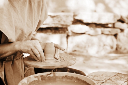 Female potter making a clay vessel  sepia toning の写真素材