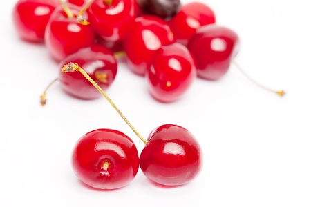 Red sweet shiny cherries on white background