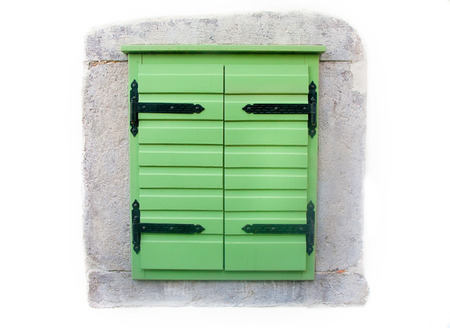 Wood window shutters with vintage metal hinges freshly painted green の写真素材