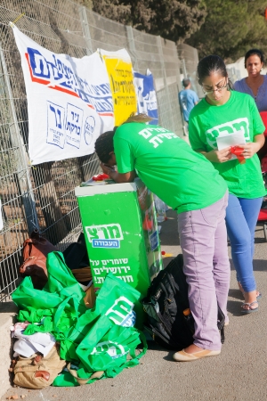 JERUSALEM - OCTOBER 22: Young people work at campaign stands of "Merets" ("Energy") party deployed near the ballot station in Jerusalem during the mayor elections on October 22, 2013, the mayor elections day in Israel.のeditorial素材