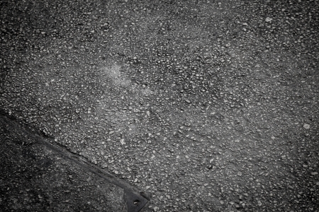 Monochrome asphalt texture with small cobblesの写真素材
