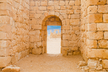 Ancient Roman stone wall and an arch opening on beautiful terraceの写真素材