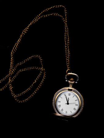 Chained vintage watch over black backgroundの写真素材