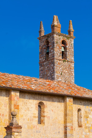 Medieval bell tower with old bells against blue skyの写真素材