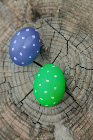 Two Easter eggs on the surface of old wood stumpの写真素材