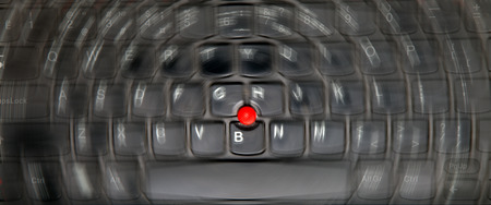 Blurry background of computer keyboard with red pointing stick - digital reality concept (motion blur)の写真素材