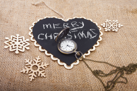 Christmas and New Year concept on sackcloth canvas with vintage watch (retro toning)の写真素材