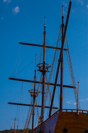 Underside view on an old sailing vessel (modern copy) ropes and gear against blue sky