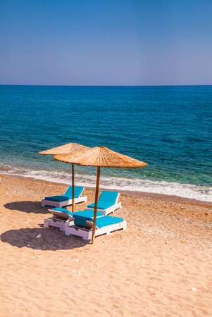 Two umbrellas on a beautiful empty beachの写真素材