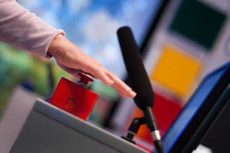 Hand pushing a red button の写真素材