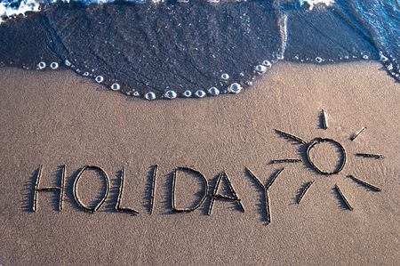 inscription Holiday on a sand and a wave の写真素材