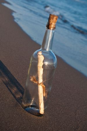 Message in a bottle stranded on the beachの写真素材
