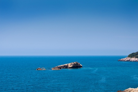 open sea under solid blue sky with lots of copyspaceの写真素材