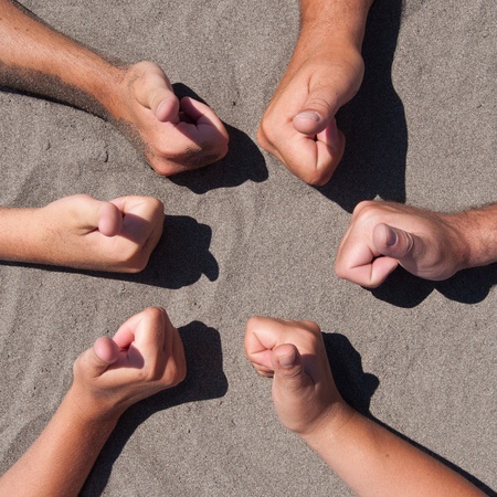 Image of  hands with thumbs up on sand - circle formの写真素材